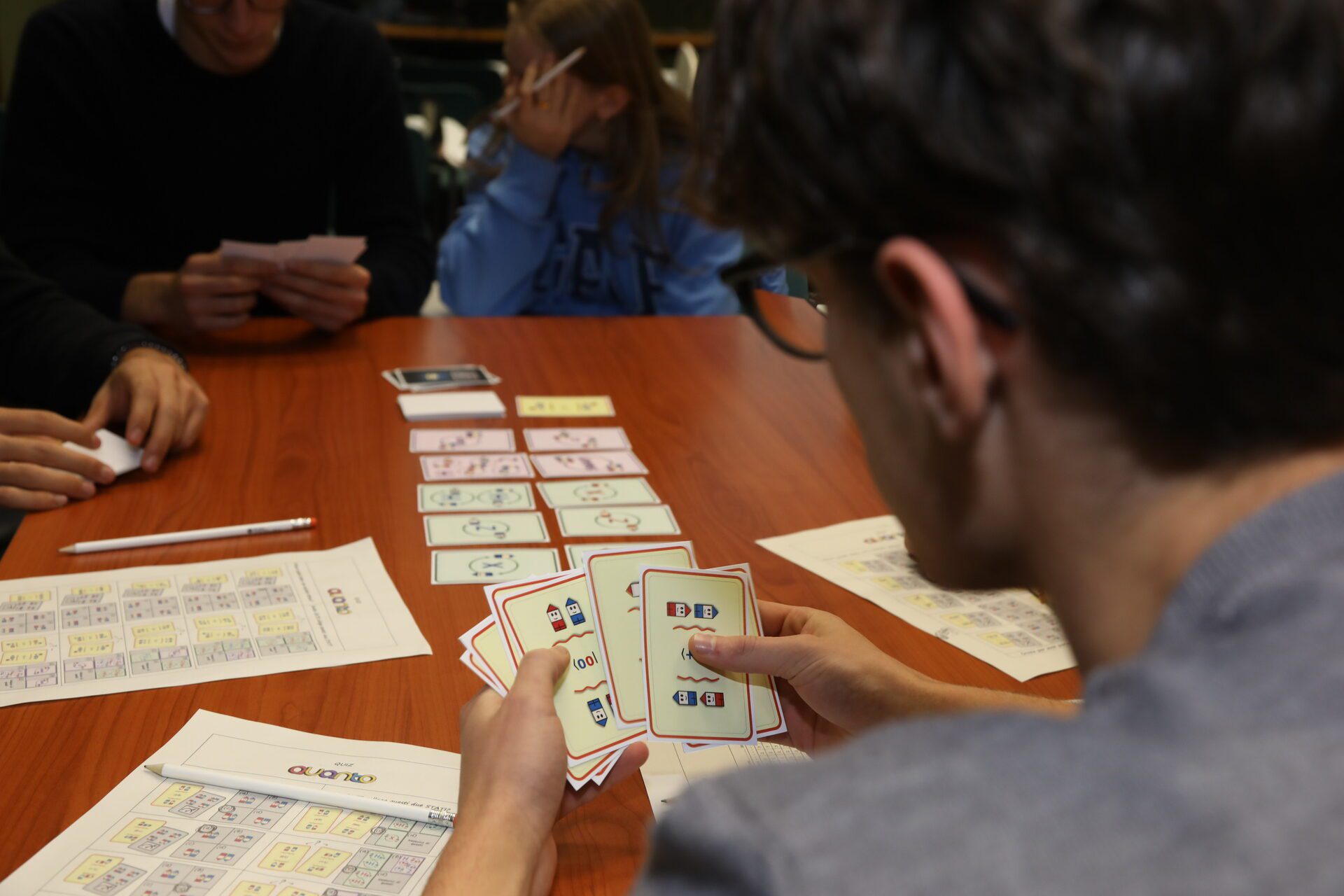 Participants using educational cards during a Q@TN outreach activity