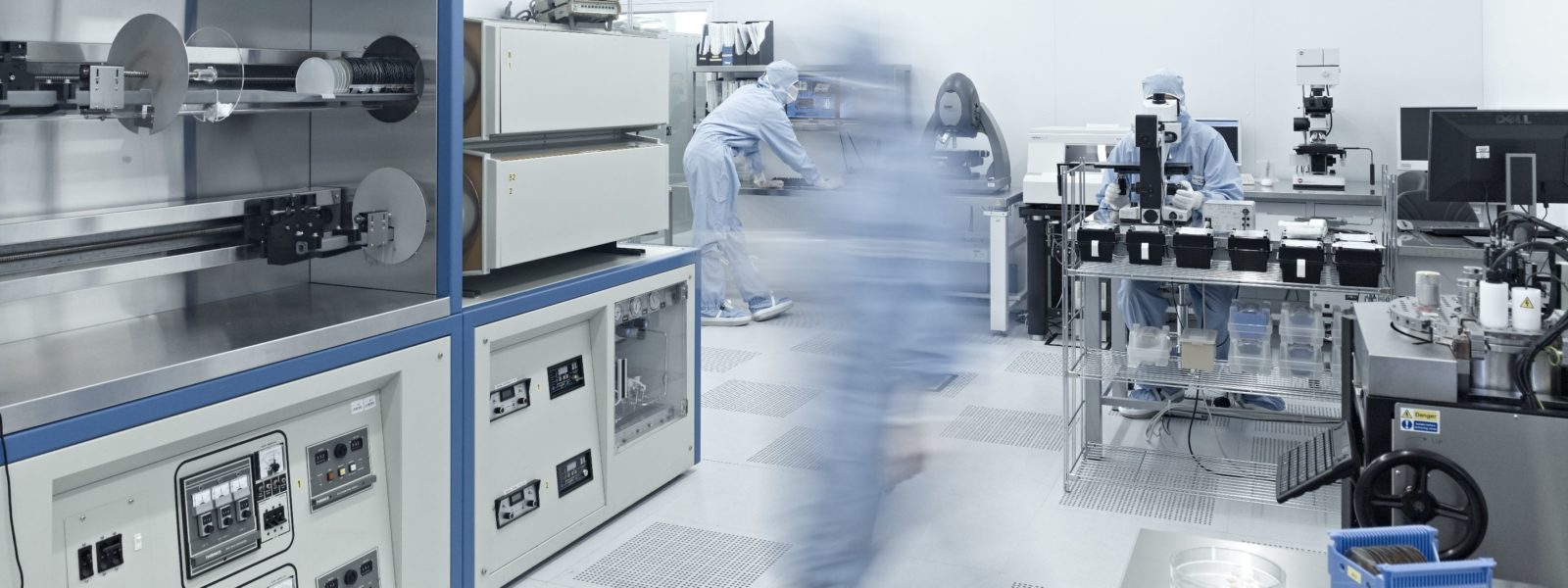 Researchers working in an FBK clean room